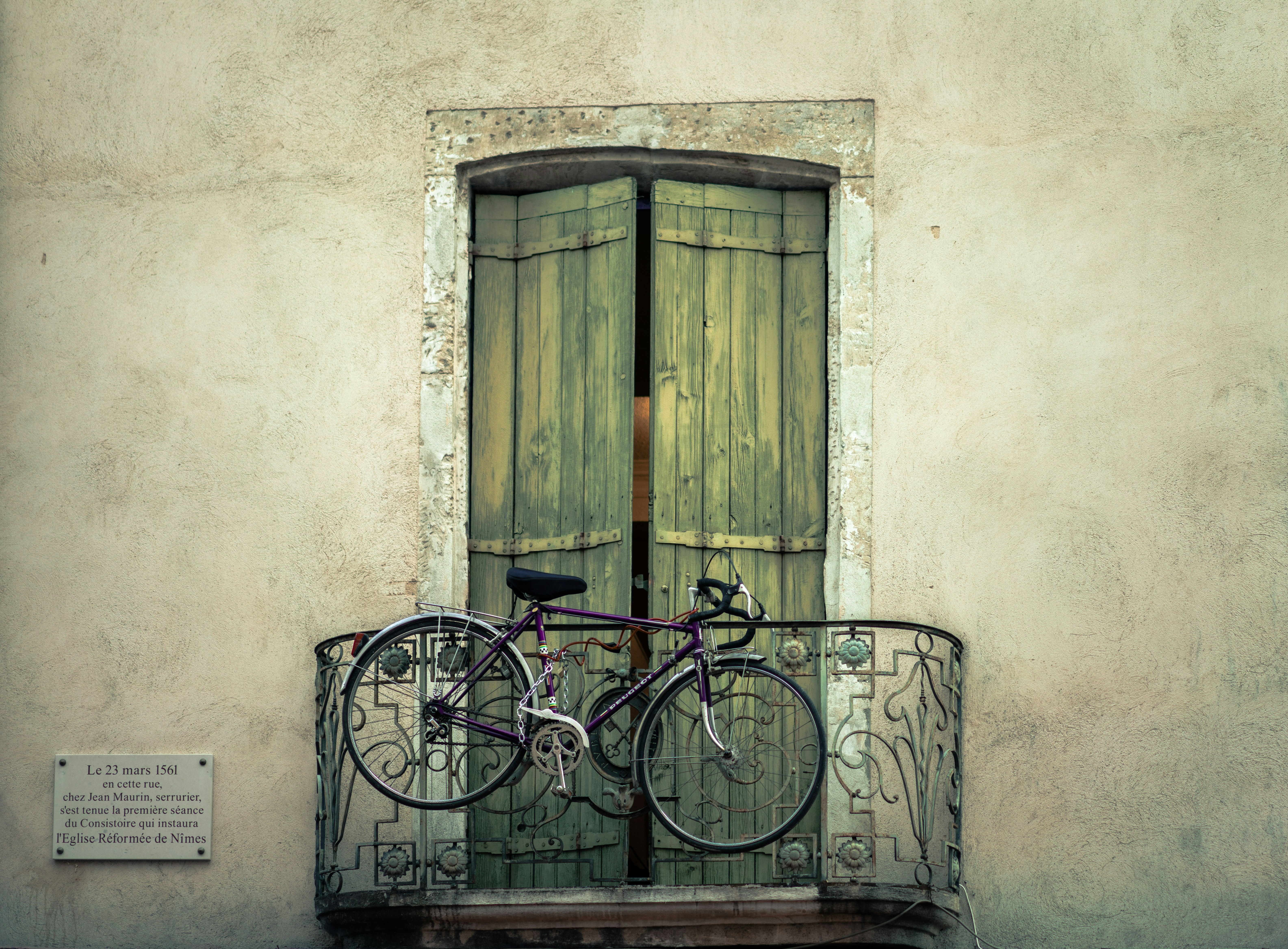 black bike hanged on false balcony